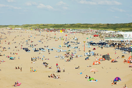 Scheveningen, Netherlands - August 24, 2021: People enjoying at a busy beach on a sunny dayのeditorial素材