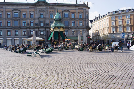 Copenhagen, Denmark - April 6, 2023: People relax and enjoy a drink at an outdoor cafe terrace in the center of Copenhagenのeditorial素材