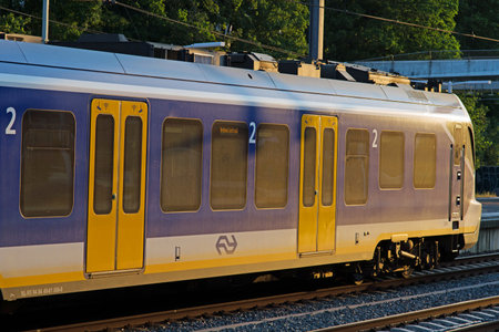 Arnhem, Netherlands - June 11, 2023: Blue, yellow and white Sprinter train from the NS waiting at platformのeditorial素材