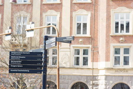Copenhagen, Denmark - April 6, 2023: Pole with a blue signpost in the center of Copenhagenのeditorial素材