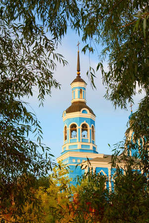 St. Nikolai's Cathedral in a frame of willow branches. A "scout" view at the cathedral. Shot in Poltavska region, Ukraineの写真素材