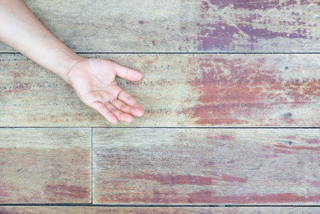 hand on a wooden boardの写真素材