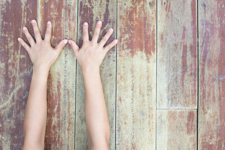 hand on a wooden boardの写真素材