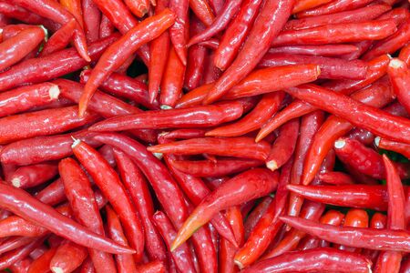 Hot red chillies as a textured food background.