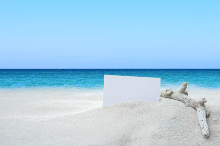 Business card on a sandy beach With a background sky and ocean. nature outdoor.Space for text Of paper squaresの写真素材