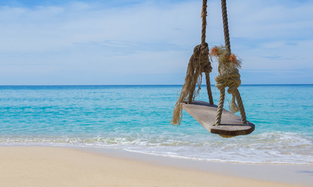 Close up rope swings, benches, swings, wooden boards for relaxing on the beach. I looked at the sea in good weather Koh Kood in Thailand.の写真素材