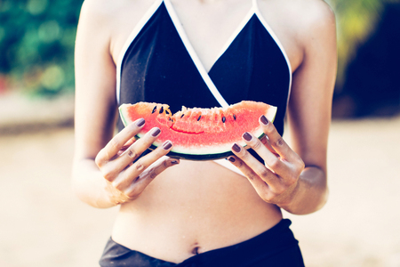 Woman with sexy fashion watermelon girl with long hair in watermelon mobile swimsuitの写真素材