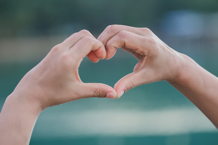 Human hands Heart shaped the sky in the background blurred.Environment Day concept. The power harmonious.heart loveの写真素材