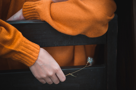 Woman hand catches hay flowers. The reflection of the lonely people.Style dark toneの写真素材