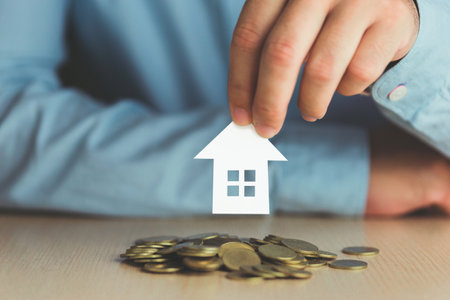 Concept Idea Investment success goals for the future paper house on pile of coins and business handsの写真素材