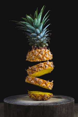 Pineapple fruit on a black background, vertical image.の写真素材