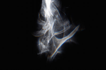 Abstract white fairy lights on black background. Close-up.
