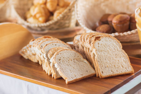 Slices of bread on a wooden tray. Selective focus.