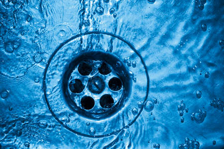 Life-giving water flows out in a hole. Image in fantastic-blue colorsの写真素材