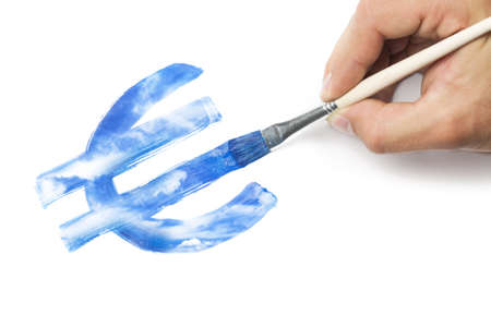 Hand with brush painting euro currency symbol from blue sky texture. Business conceptual image: devaluation, inspiration or making money concept.の写真素材