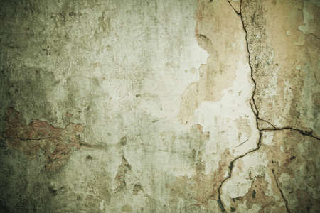 Shabby cracked wall green grunge background with dark bordersの写真素材