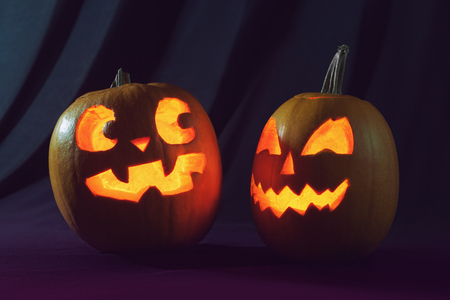 Two Halloween pumpkins scaring each otherの写真素材