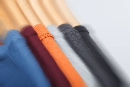 Concept of choosing cloth. Variety of t-shirts. Motion effect, selective focus