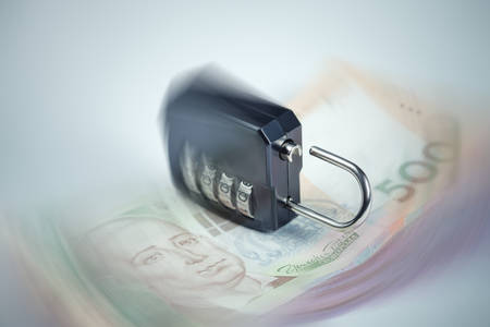 Ukrainian hryvnia fall concept. Ulocked lock as a sign of the beginning of financial chaosの写真素材