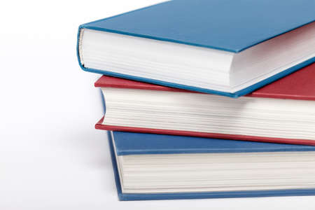 Three books on white background up close. Low aperture shot, selective focus.