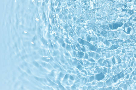 Blue clear water background with ripplingの写真素材