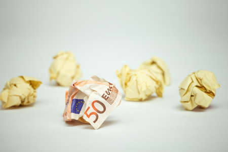 50 euro bill among crumpled office paper. Financial concept image.の写真素材