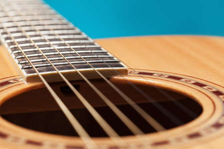 Acoustic guitar on blue background upcloseの写真素材