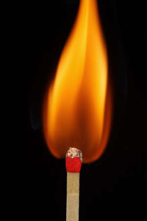One quiet burning match on black background. Match burning details