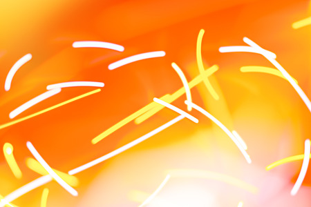 Flying light sparks abstract on warm color background