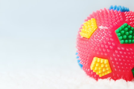 Children colorful single ball (toy) background with empty space. Soft blurry shot, selective focusの写真素材