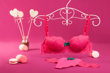 Sweet underwear (bra and panties) set with macarons and heart shaped souvenir candiesの写真素材
