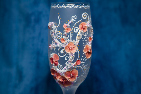 two glasses of champagne on snow ready for christmas celebration, on red backgroundの写真素材