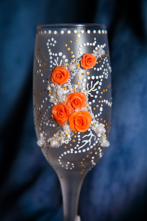 two glasses of champagne on snow ready for christmas celebration, on red backgroundの写真素材
