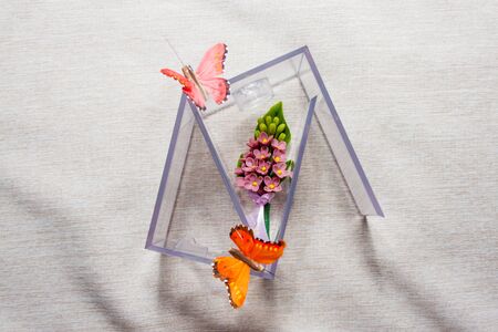 box of wedding accessories with boutonniere, perfumes