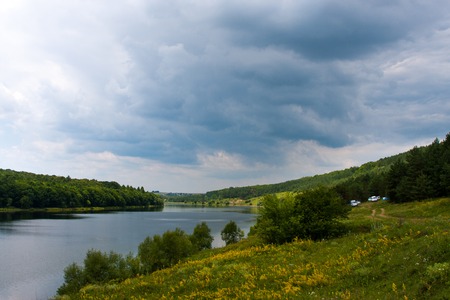 summer landscape misty morning on the river in the west Ukraine and the railroad along the shoreの写真素材