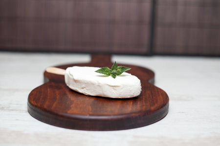 Ice cream bar coated with chocolate on a slate boardの写真素材