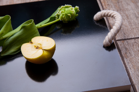 Apple rose shaped pie and cup of tea on the serving tray. Homemade apple cake for tea time. Breakfast tea with sweet apple pastry.の写真素材