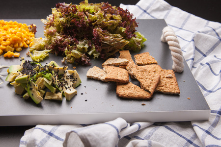 blond business women in black with tulips in hands isolated on whiteの写真素材