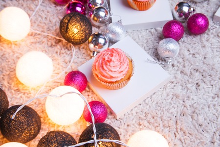 Christmas cake with New Year's toys and lightsの写真素材