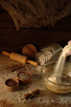 Cooking cookies with cinnamon. Mixing. The ingredients on a wooden board.