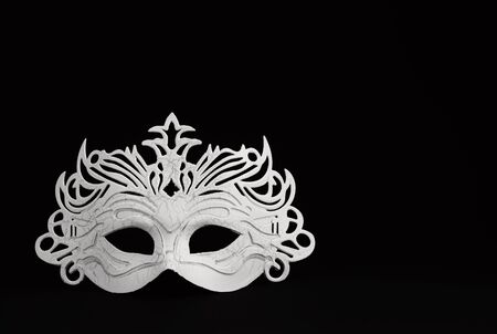White stylish carnival mask on a black backgroundの写真素材
