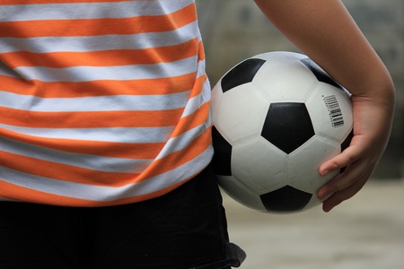A  soccer ball is hold by a little boy.の写真素材