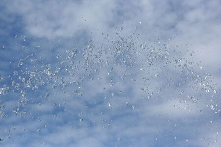 water drop in blue sky backgroundの写真素材