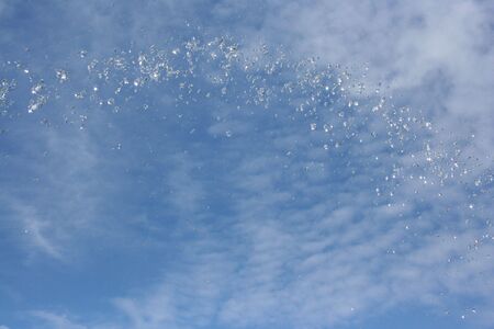 water drop in blue sky backgroundの写真素材