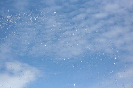 water drop in blue sky backgroundの写真素材