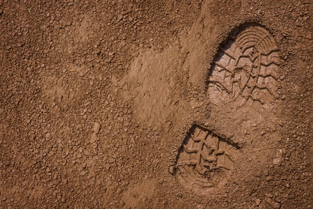 Imprint of the shoe on mud with copy spaceの写真素材