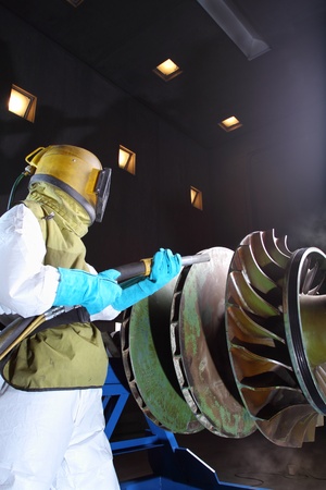 A worker working in a sandblast workshopの写真素材