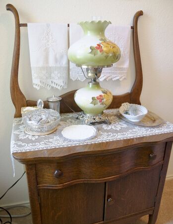 Close-up of antique dresser with antiques sitting on top of dresser