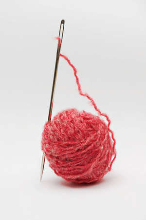 Wool ball  with needle on white background extreme close upの写真素材