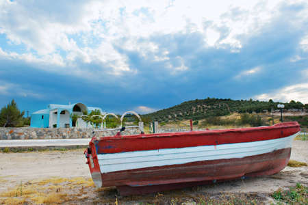 Red fishing boat with a backdrop Chapelの写真素材